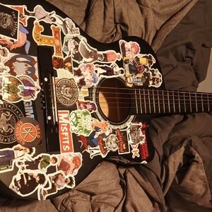 Black Acoustic Guitar with Colorful Stickers